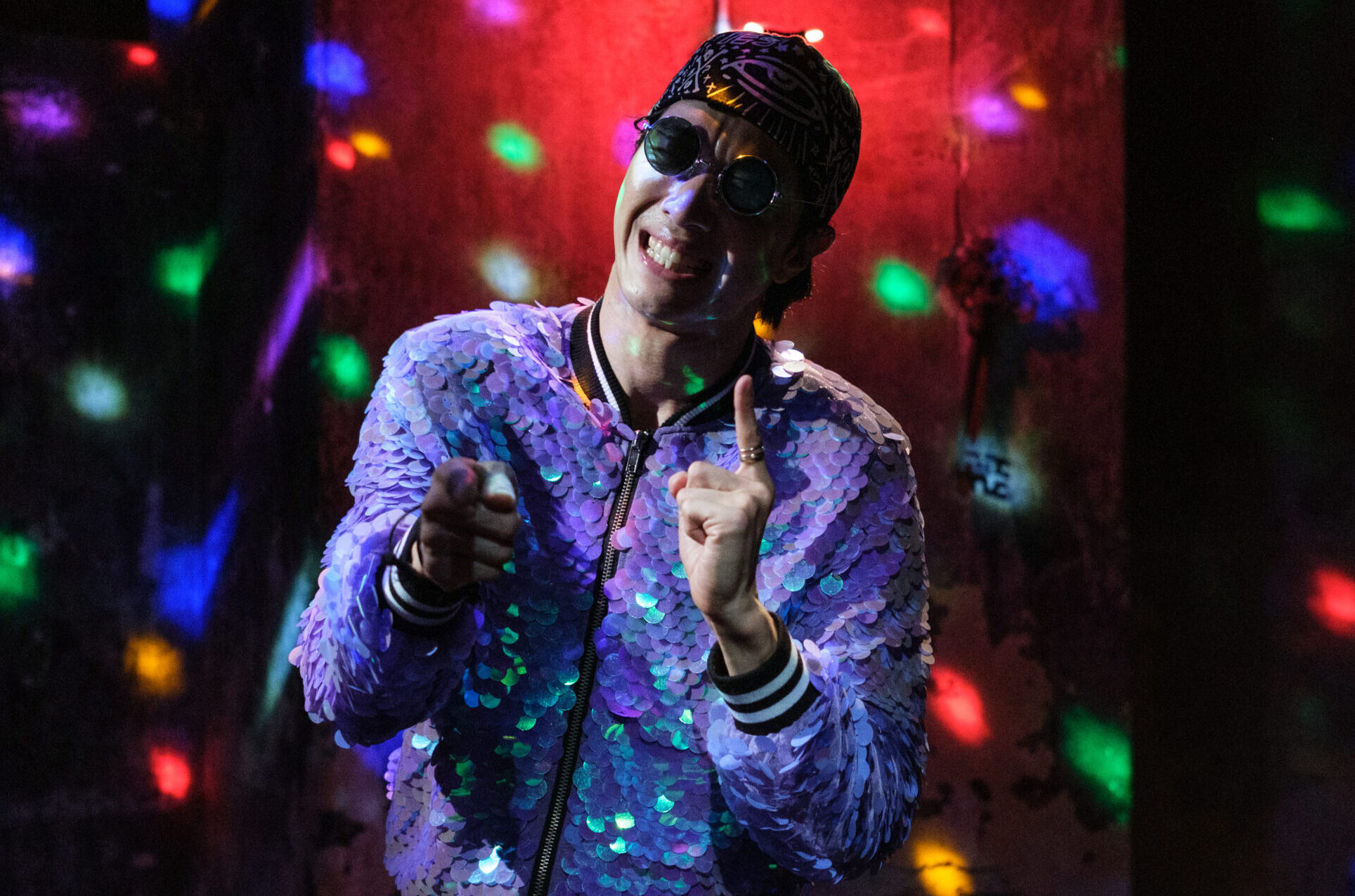 A person dancing in a room with lights